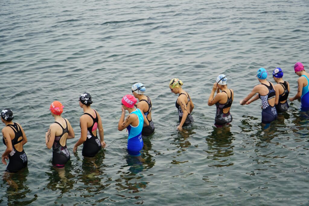 Athletes in wetsuits ready for a triathlon swimming leg in Mudanya, Türkiye.